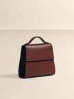 Brown leather briefcase on a beige background