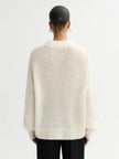 Back of model wearing Soft Goat Alpaca Crewneck Sweater in White