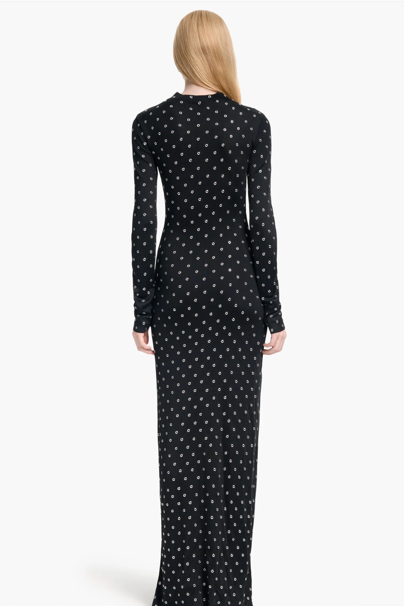 Black dress with white star pattern worn by a model on a white background