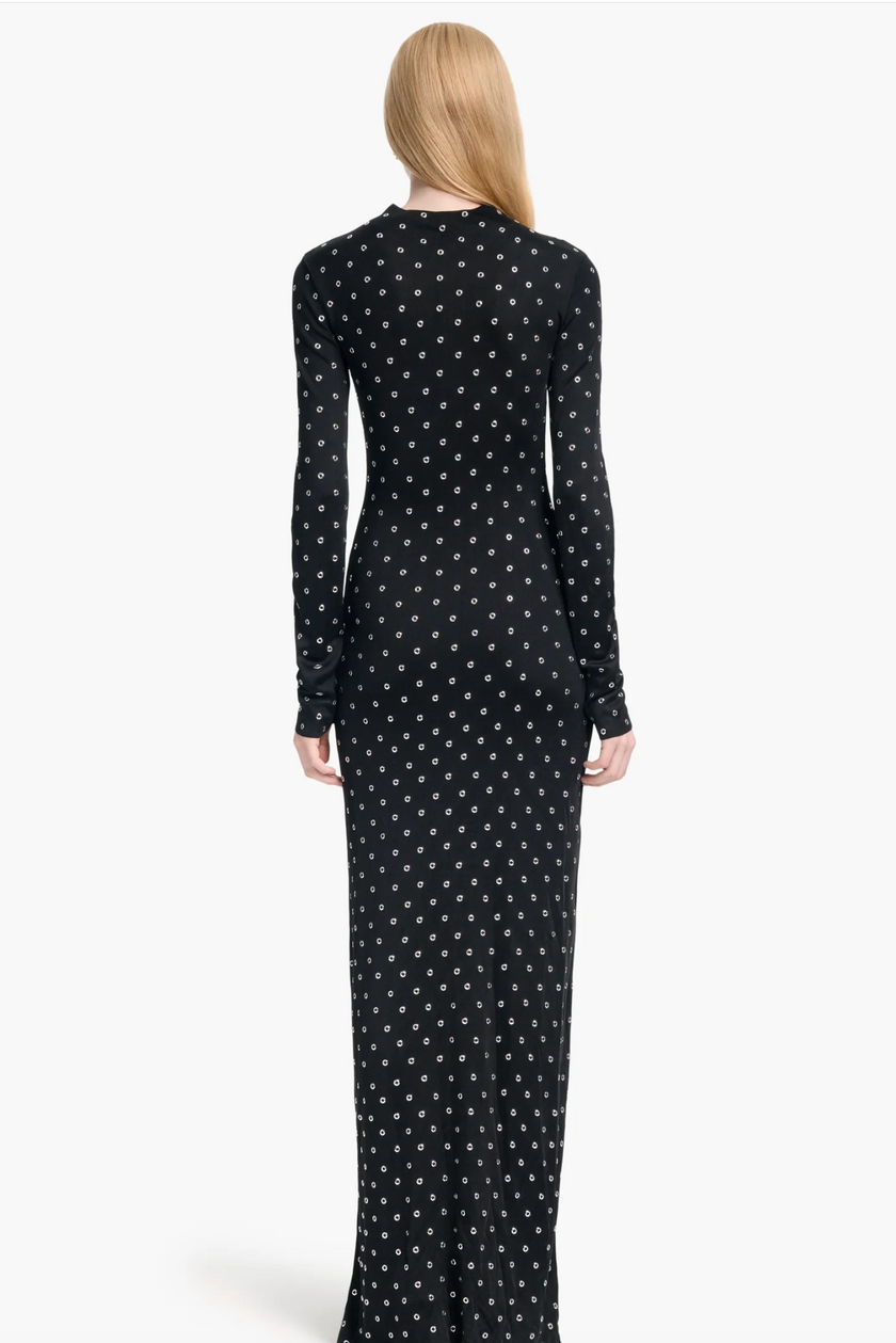 Black dress with white star pattern worn by a model on a white background